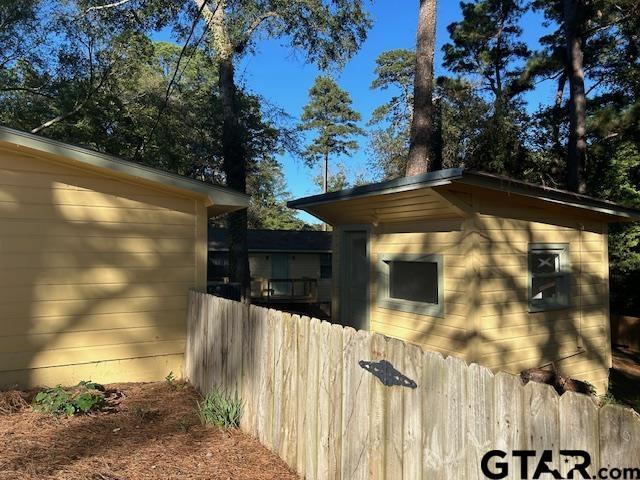 view of home's exterior featuring fence