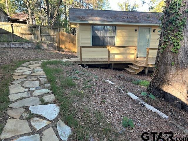 exterior space featuring a deck and fence