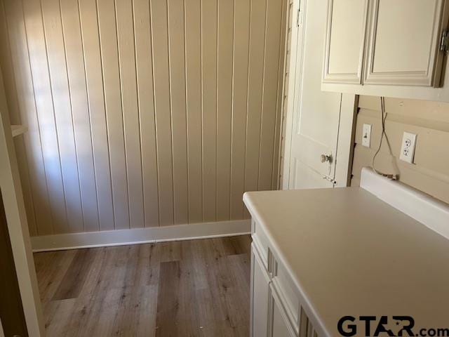 interior space featuring baseboards and wood finished floors