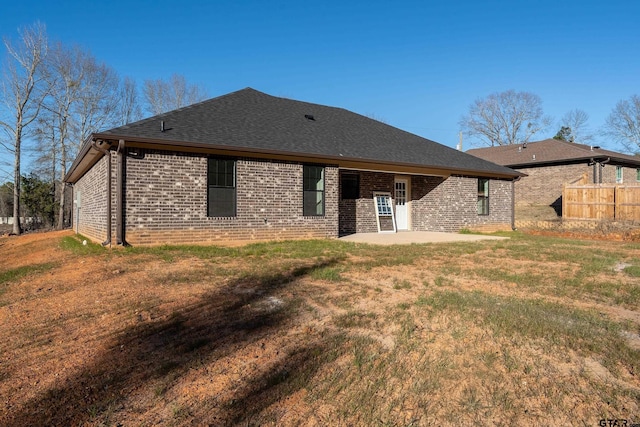 back of property featuring a patio and a yard