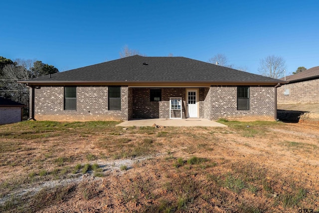 back of property featuring a yard and a patio