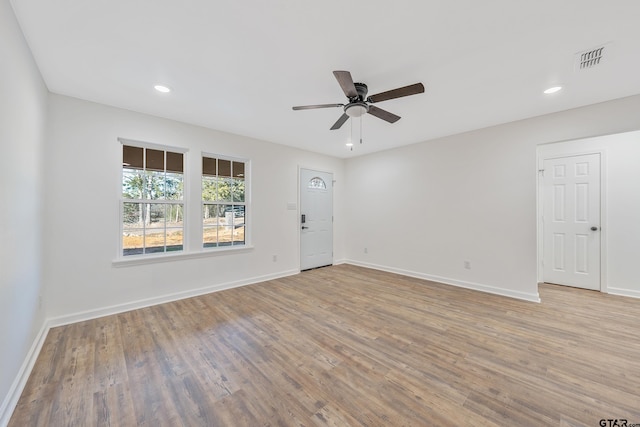 spare room featuring light hardwood / wood-style flooring and ceiling fan