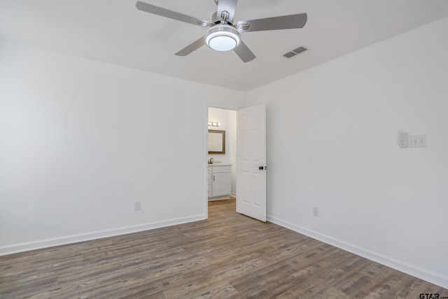 empty room featuring sink, hardwood / wood-style floors, and ceiling fan