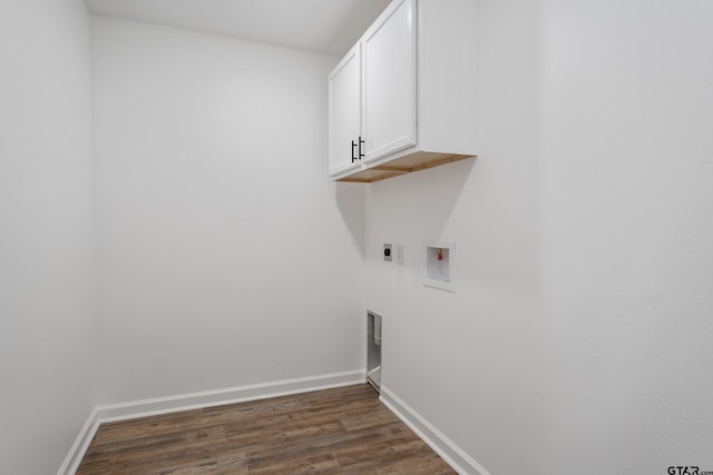 laundry area featuring electric dryer hookup, washer hookup, dark hardwood / wood-style flooring, and cabinets