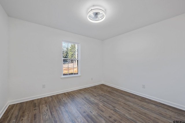 empty room with dark hardwood / wood-style flooring