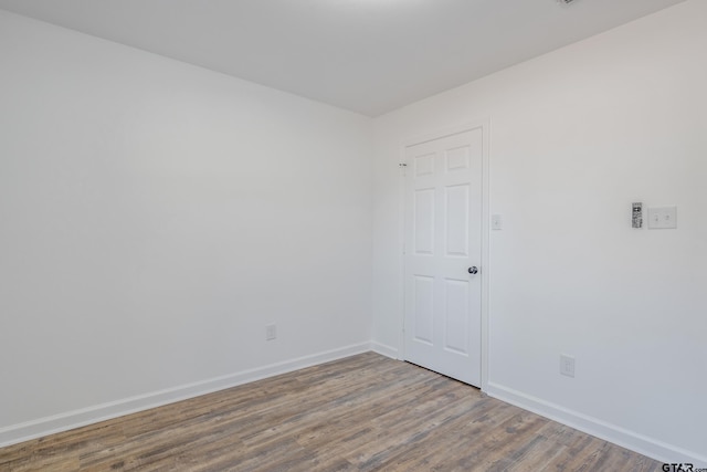 spare room featuring wood-type flooring