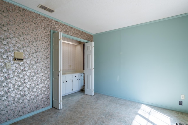 507 E Longview St, Arp, TX 75750 - unfurnished bedroom featuring wallpapered walls, light colored carpet, and crown molding