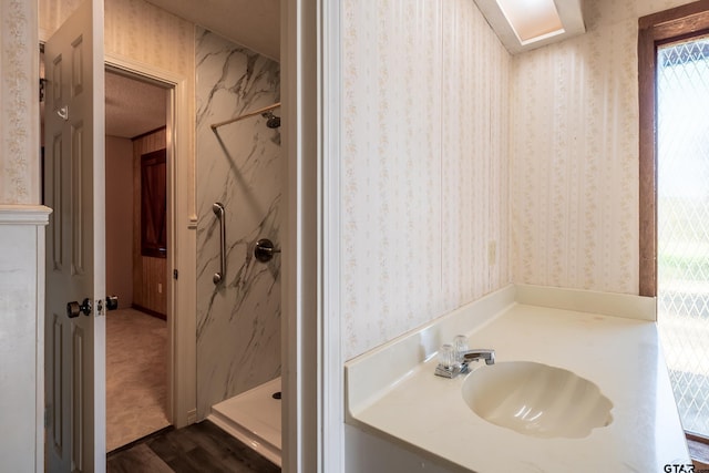 507 E Longview St, Arp, TX 75750 - full bathroom featuring a marble finish shower, wallpapered walls, vanity, and wood finished floors