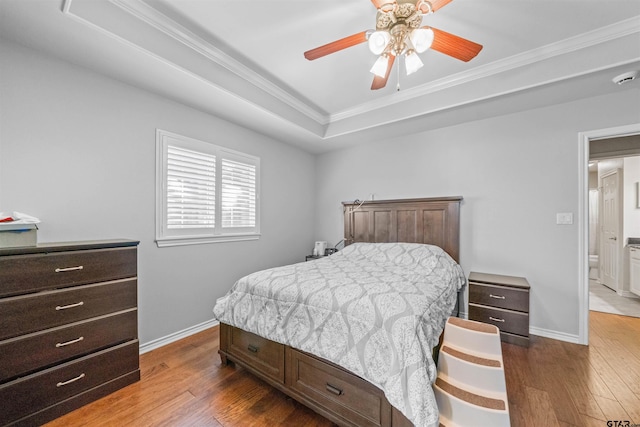 1521 Rice Rd # A105, Tyler, TX 75703 - bedroom featuring hardwood / wood-style floors, ornamental molding, baseboards, and a raised ceiling