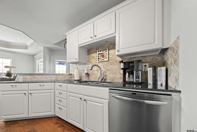 1521 Rice Rd # A105, Tyler, TX 75703 - kitchen featuring stainless steel dishwasher, a sink, decorative backsplash, white cabinets, and dark wood-style flooring