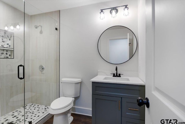 1612 Woodland Hills Dr, Tyler, TX 75701 - bathroom featuring vanity, a shower stall, and wood finished floors