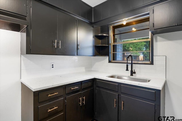 1612 Woodland Hills Dr, Tyler, TX 75701 - kitchen featuring tasteful backsplash, light stone counters, and open shelves