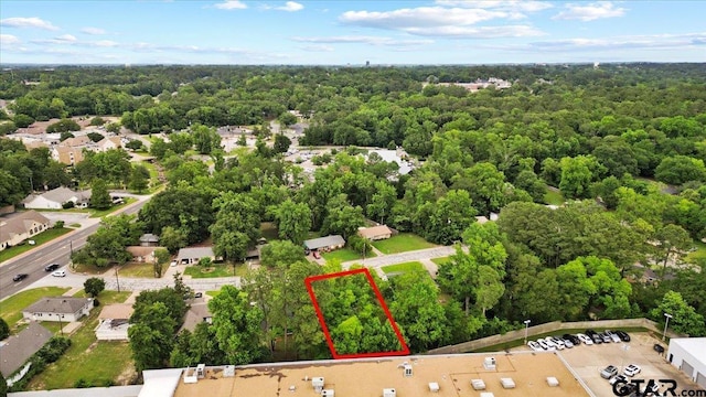 1612 Woodland Hills Dr, Tyler, TX 75701 - aerial overview of property's location with property parcel outlined and a forest