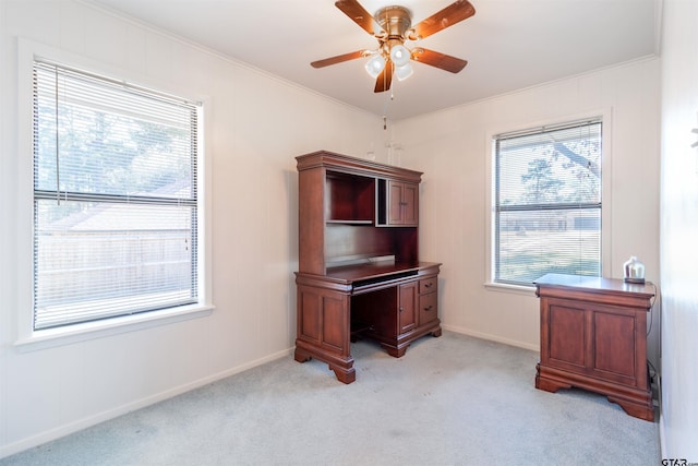 office area with baseboards, ornamental molding, a ceiling fan, and light colored carpet