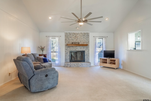 living room featuring a wealth of natural light, vaulted ceiling, carpet flooring, and a fireplace