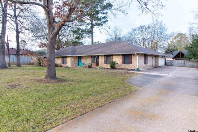 single story home with brick siding, concrete driveway, fence, a garage, and a front lawn