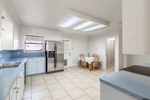 kitchen with white cabinetry, sink, stainless steel fridge with ice dispenser, and light tile patterned floors