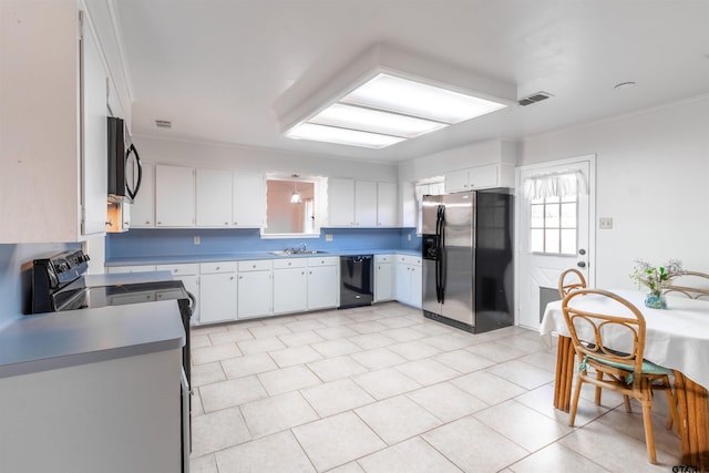 kitchen with sink, black appliances, and white cabinets