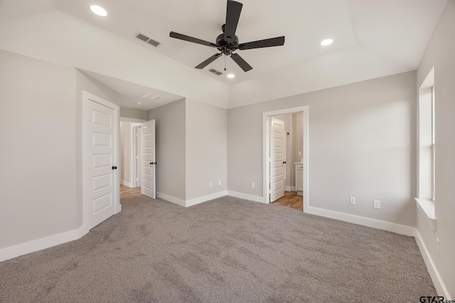 unfurnished bedroom featuring ensuite bath, ceiling fan, and light colored carpet