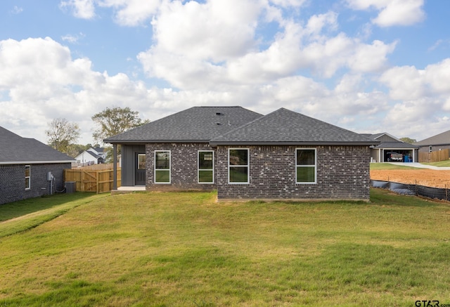 back of house featuring a yard