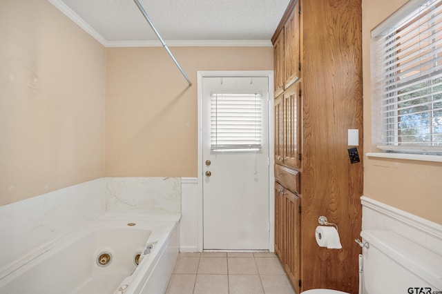 bathroom featuring ornamental molding, tile patterned flooring, a textured ceiling, and a bathtub