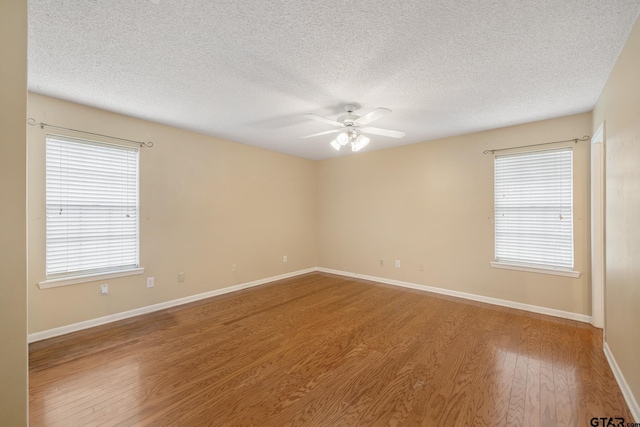 unfurnished room with hardwood / wood-style flooring, a textured ceiling, and ceiling fan