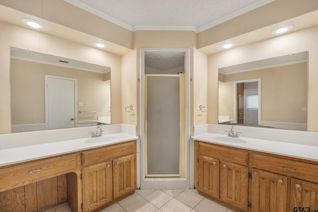 bathroom featuring tile patterned floors, a shower with door, and vanity