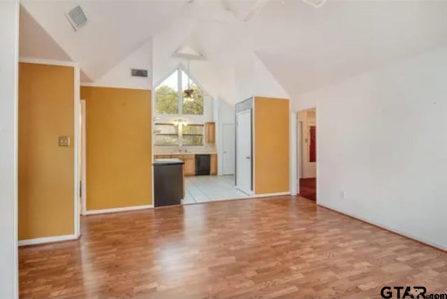 interior space with high vaulted ceiling and light hardwood / wood-style flooring