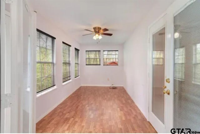 unfurnished room with light wood-type flooring and ceiling fan