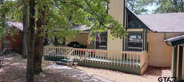 view of side of property with a wooden deck