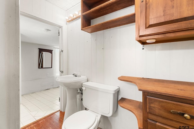 bathroom featuring hardwood / wood-style floors and toilet