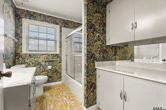 full bathroom featuring vanity, combined bath / shower with glass door, and toilet