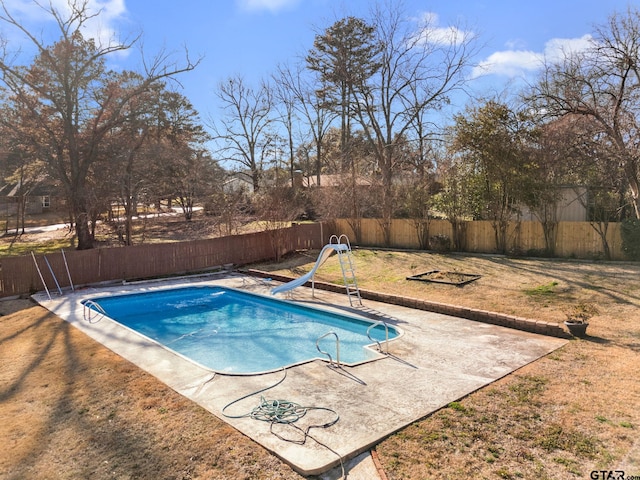 view of swimming pool with a water slide and a patio area