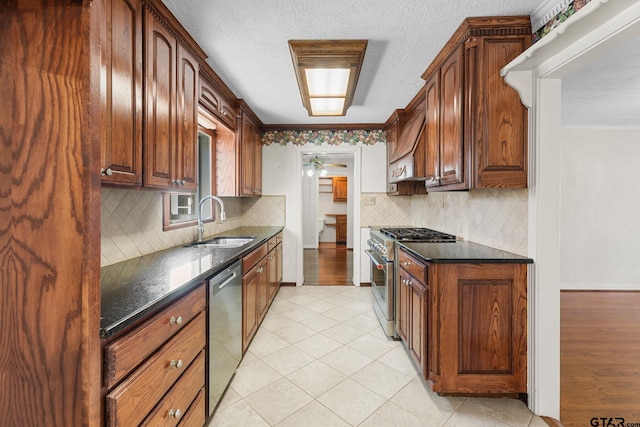 kitchen with premium range hood, stainless steel appliances, sink, and decorative backsplash