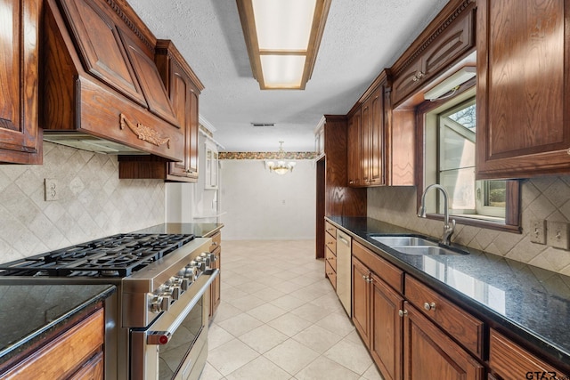 kitchen with premium range hood, appliances with stainless steel finishes, light tile patterned flooring, sink, and a chandelier