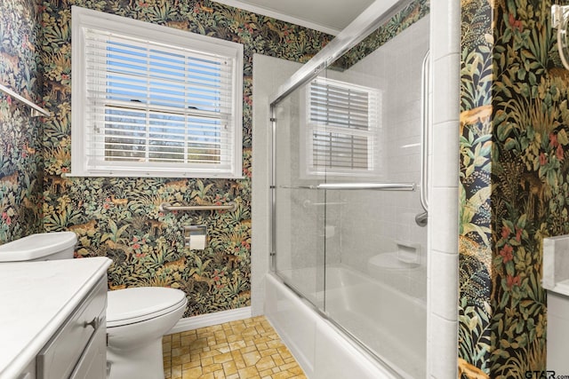 full bathroom featuring vanity, toilet, and combined bath / shower with glass door