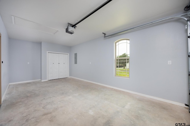 garage with electric panel and a garage door opener