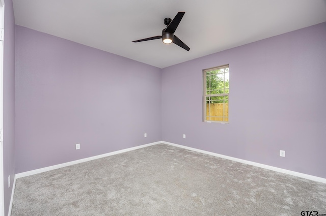 carpeted empty room featuring ceiling fan