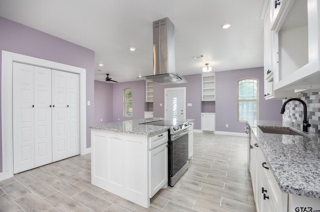 kitchen featuring a kitchen island, sink, exhaust hood, white cabinets, and stainless steel electric range oven