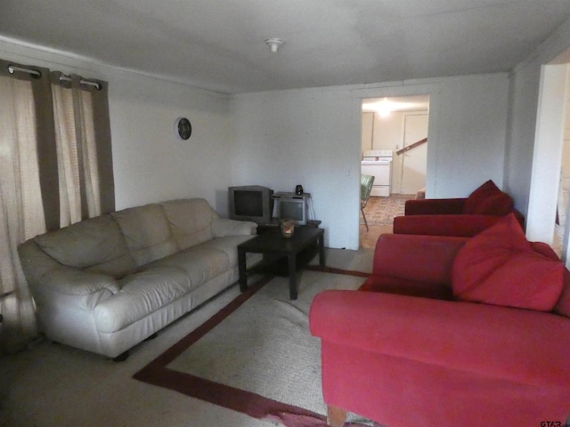 carpeted living room with washer / clothes dryer