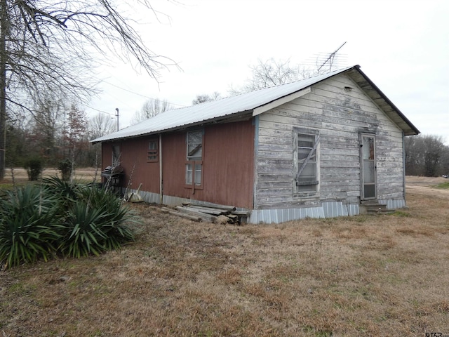 view of side of home featuring a lawn