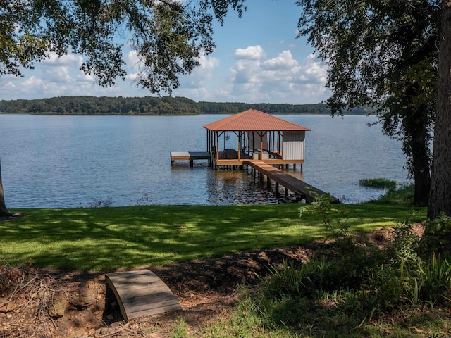 view of dock featuring a yard and a water view