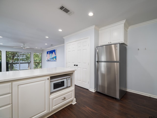 kitchen with ornamental molding, white cabinetry, stainless steel refrigerator, dark hardwood / wood-style floors, and ceiling fan