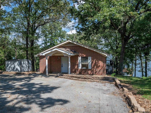 view of front facade featuring a shed