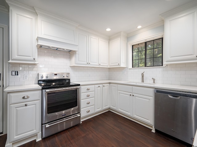 kitchen featuring stainless steel appliances, dark hardwood / wood-style floors, white cabinetry, and sink