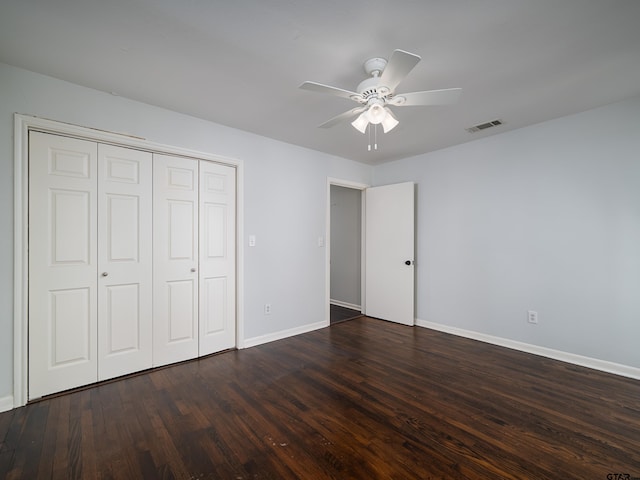 unfurnished bedroom featuring ceiling fan, dark hardwood / wood-style floors, and a closet