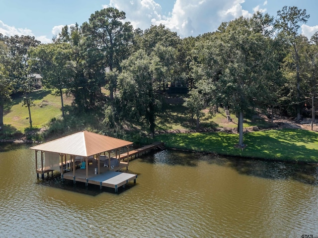 dock area featuring a lawn and a water view