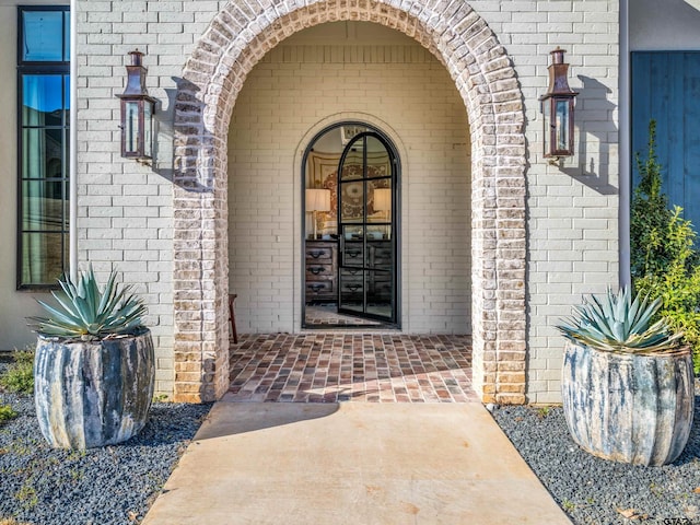 entrance to property featuring brick siding