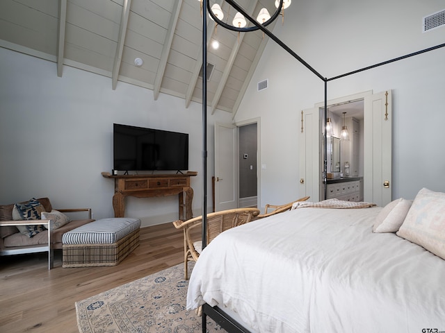 bedroom featuring high vaulted ceiling, beam ceiling, visible vents, and wood finished floors