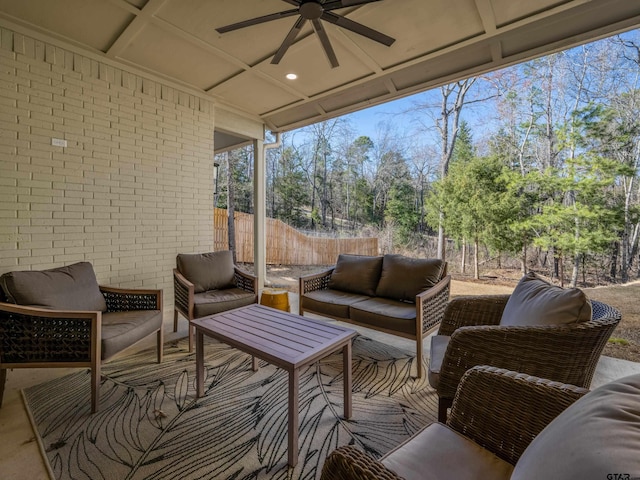 sunroom with a ceiling fan, a healthy amount of sunlight, and coffered ceiling